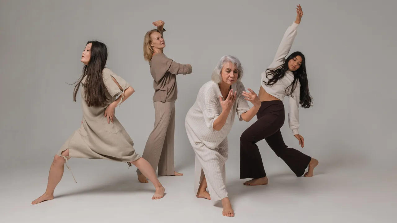 A woman dancing barefoot with her arms raised